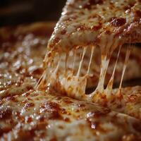 Deliciously cheesy pizza with gooey mozzarella being pulled from a fresh oven-baked pie in a cozy restaurant setting photo