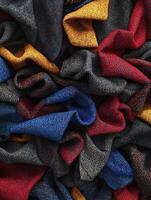 Colorful fabrics in various textures and patterns arranged in a disorganized yet artistic manner photo