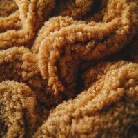 Textured boucle fabric in warm tones creates a cozy and inviting atmosphere for fashion or interior design applications photo