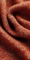 Boucle fabric shows rich texture and warmth in deep orange and brown tones photo