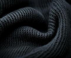 Luxurious dark boucle fabric showcasing intricate texture and depth in soft woven threads during a close-up view photo