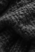 Soft looped texture of black boucle fabric showcasing intricate detail and warmth suitable for various design projects photo