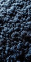 Textured close-up of boucle fabric showcasing intricate patterns in deep blue tones suitable for various applications photo
