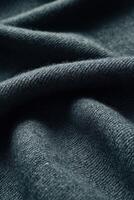 Close-up of luxurious boucle fabric showcasing intricate texture and depth in a rich green color photo