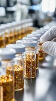 Laboratory technician handling glass vials filled with golden mineral samples in a research facility during daylight hours photo