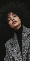 Stylish model showcasing boucle fabric jacket with voluminous curls in urban setting during fall season photo