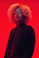 Stylish model showcases boucle fabric fashion against vibrant red backdrop in an urban setting photo