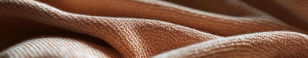 Boucle fabric showcases intricate texture and warmth in rich brown hues softly draped across a surface photo
