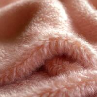 Soft and cozy boucle fabric texture perfect for blankets and upholstery in a warm, inviting setting photo