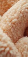 Soft boucle fabric texture showcasing intricate patterns in a warm tone perfect for interior design and fashion applications photo