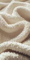 Soft and textured boucle fabric in warm neutral tones spread out for crafting or design purposes photo