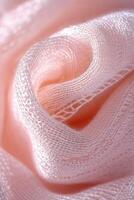 Textured boucle fabric in soft pink hue revealing delicate woven patterns and swirls photo