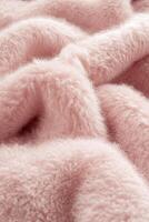 Soft boucle fabric in a subtle blush hue, perfect for cozy home decor and fashion applications photo