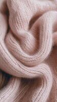 Boucle fabric texture in soft pink drapes, highlighting intricate weave and fibers, perfect for cozy garments and home decor photo