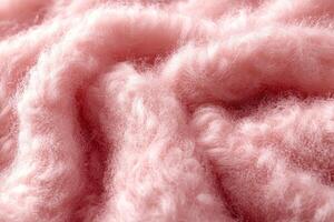 Soft pink boucle fabric texture showcasing a cozy and warm feel for textile enthusiasts and fashion designers photo