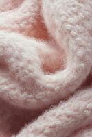 Cozy pink boucle fabric texture with soft fibers creates a warm aesthetic for interior design or fashion projects photo