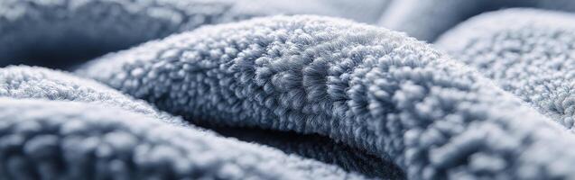 Boucle fabric texture showcasing soft, intertwined fibers in a calm, muted blue hue photo