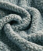 Textured boucle fabric in soft blue, showcasing intricate loops and cozy depth for fashion or decor applications photo