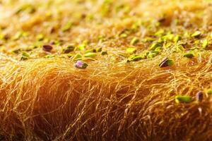 Delicate kunafa topped with crushed pistachios served at a local dessert shop for an evening treat photo