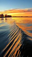 Sunset over the water with waves in the background photo