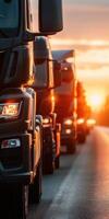 Trucks lined up on the highway during sunset with warm sunlight illuminating the scene and highlighting details photo
