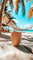 Warm beach day with a refreshing drink in hand and a hammock swaying nearby under palm trees photo
