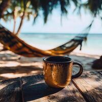 Morning coffee by the beach with a hammock in the background on a tranquil tropical morning photo