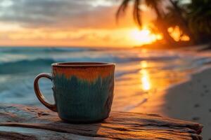 Enjoying a warm cup of coffee on the beach at sunset with gentle waves in the background photo