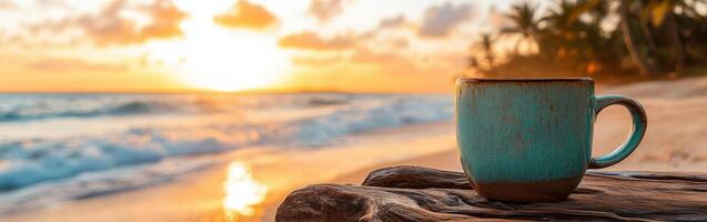 Enjoying a warm beverage while watching the sunset on a tranquil beach during a summer evening photo