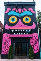 A building with a colorful monster on the side photo