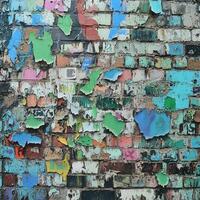 Colorful graffiti layers on a weathered brick wall in an urban setting photo