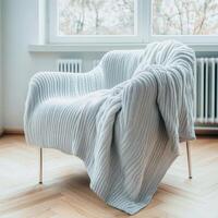 Cozy living room with plush armchair and blanket photo
