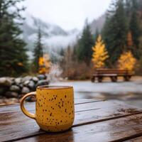 Steaming coffee by a serene lake photo