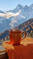 Warm coffee against mountain backdrop photo
