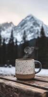 Steaming coffee in snowy mountains photo