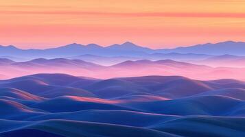 A colorful sunset over mountains and hills photo