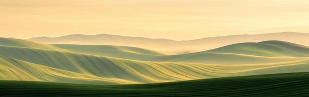 A green hill with mountains in the background photo