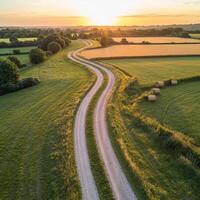 An aerial view of a country road at sunset photo