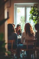 A group of people sitting around a table in a room photo
