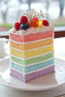 A rainbow cake with berries on top photo