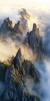 A mountain range with fog and clouds in the sky photo
