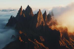 A mountain range is seen in the clouds photo