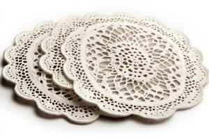 Crocheted doilies forming elegant and intricate patterns are lying on white background photo