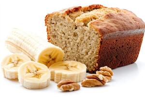 Homemade banana bread loaf with fresh bananas and pecan nuts photo