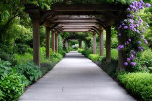 Wooden pergola covering a paved path in a lush garden photo