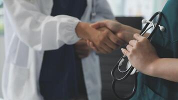 A doctor shaking hands with another person video