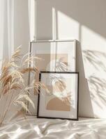 A framed picture and some plants on a bed photo