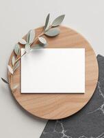 Blank card mockup on marble plate with eucalyptus branch photo
