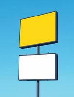 Two blank billboards on a pole against a blue sky photo