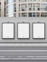 Three blank square billboards on a wall in front of a building photo